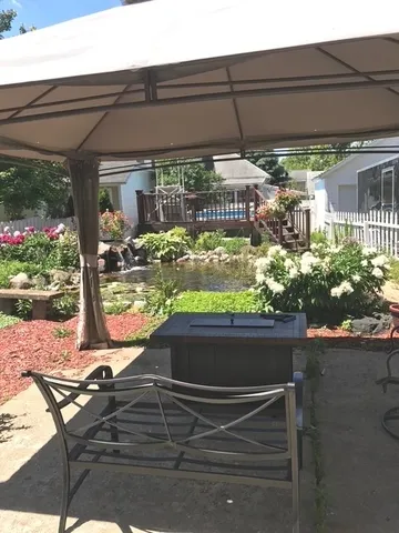 a view of a patio with table and chairs potted plants