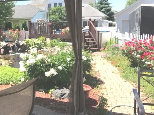 a front view of a house with a yard outdoor seating and garden