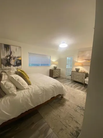 a spacious bedroom with a bed and window