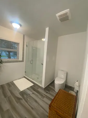 a bathroom with a toilet and a shower