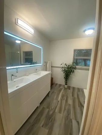 a bathroom with a sink and mirror