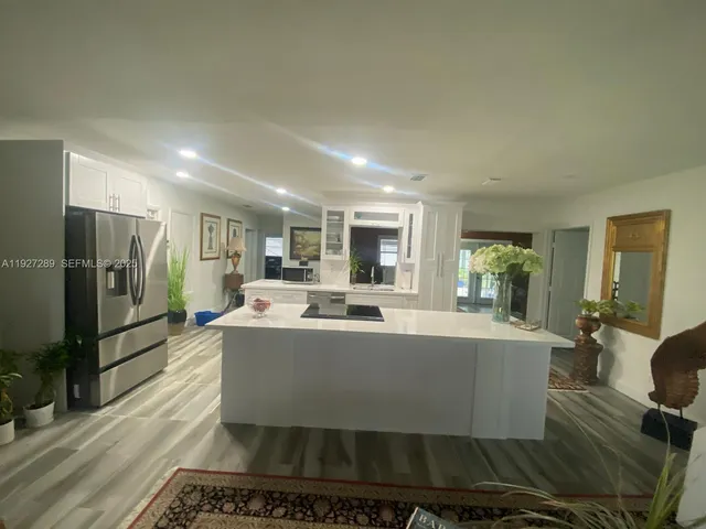 a view of a living room and kitchen with furniture