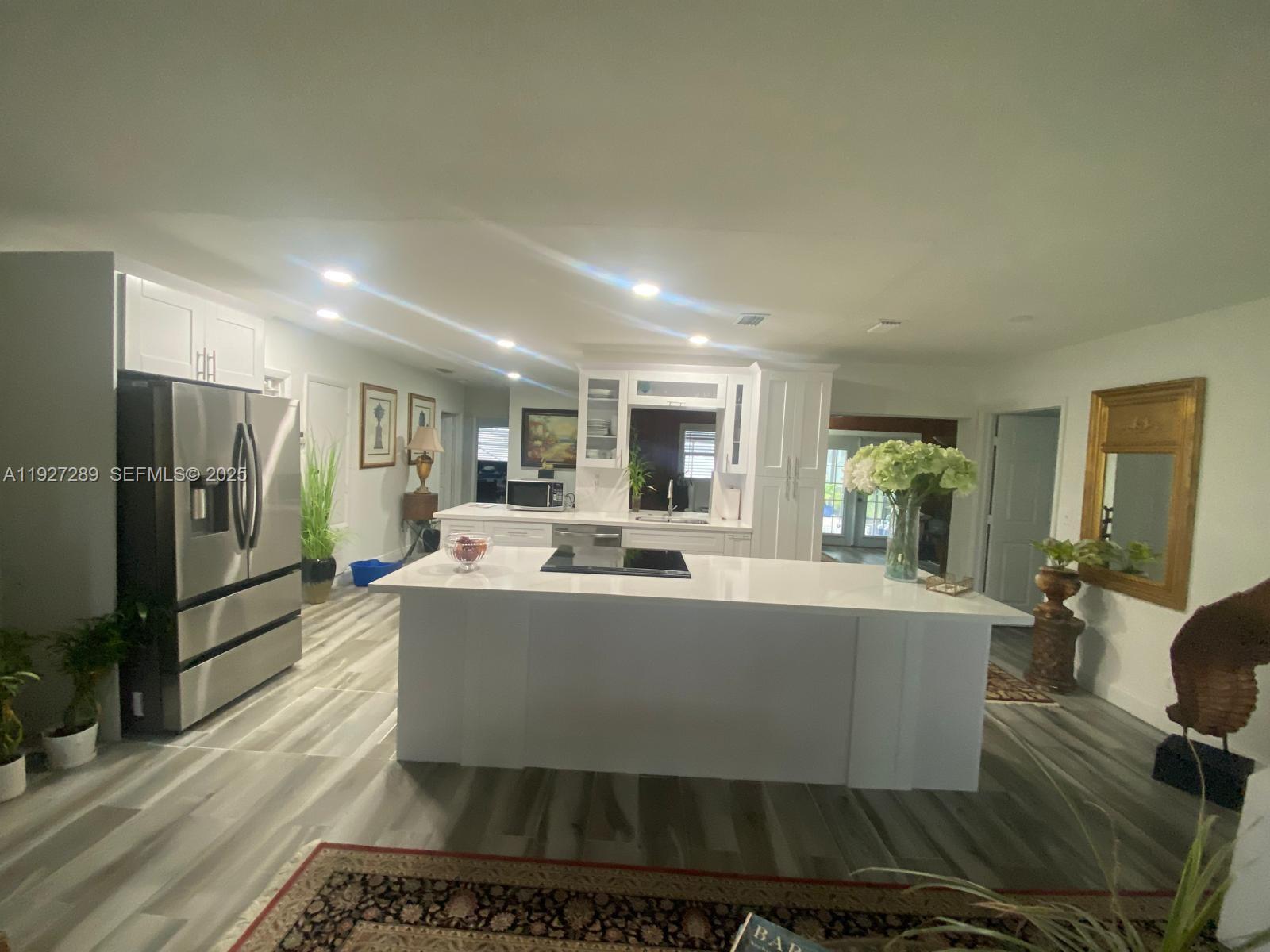 1641 Northwest 9th Street Boca Raton, FL 33486 - Photo 6 of 11 a view of a living room and kitchen with furniture