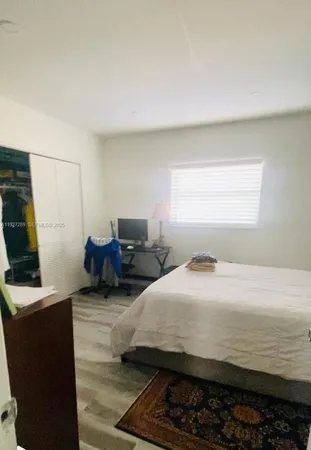 a bedroom with bed and window