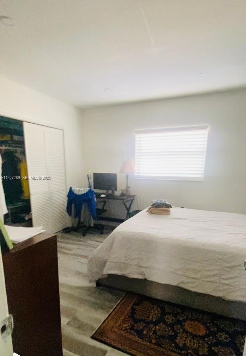 1641 Northwest 9th Street Boca Raton, FL 33486 - Photo 9 of 11 a bedroom with bed and window