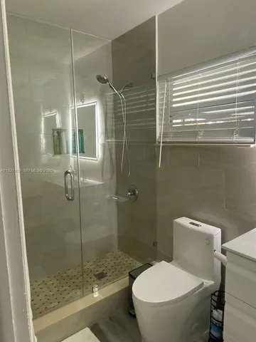 a bathroom with a toilet and a shower