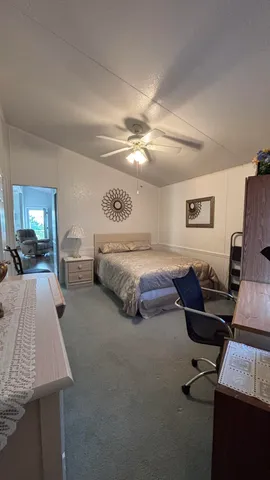 a spacious bedroom with a bed and furniture