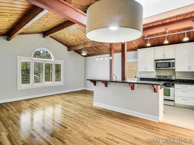 a view of a kitchen with a sink and microwave