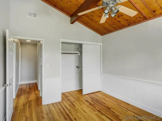 a view of a room with wooden floor