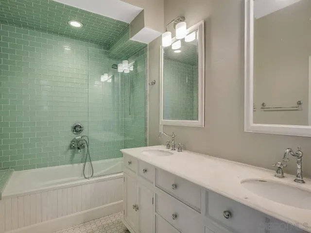 a bathroom with a sink double vanity and a mirror