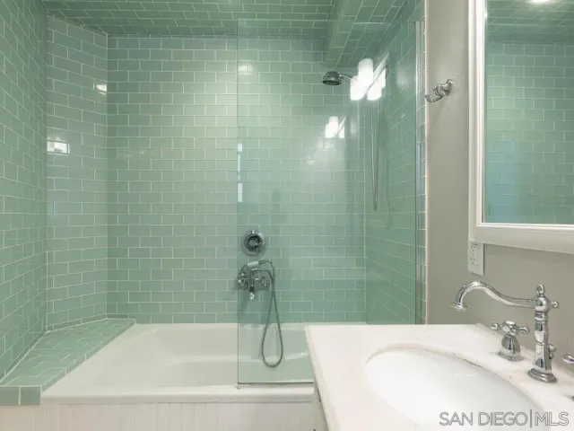 a bathroom with a sink and shower