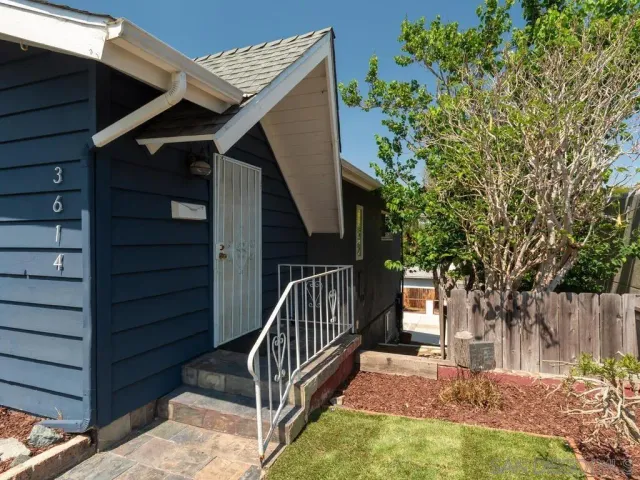 a view of backyard with deck and wooden fence