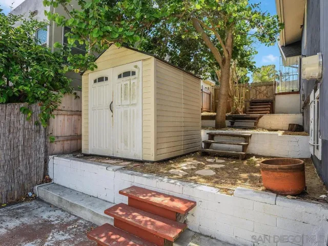 a view of backyard with outdoor seating and trees