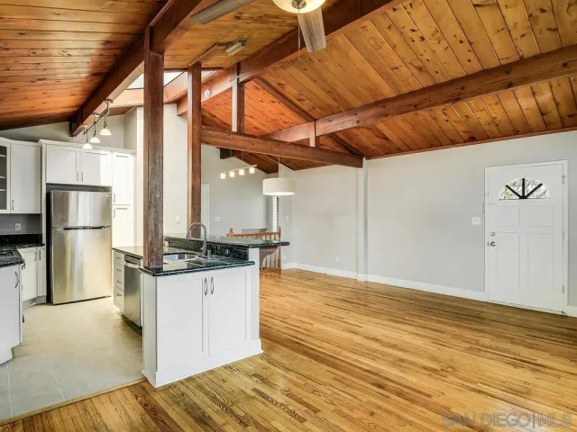 a kitchen with stainless steel appliances granite countertop a stove and a refrigerator