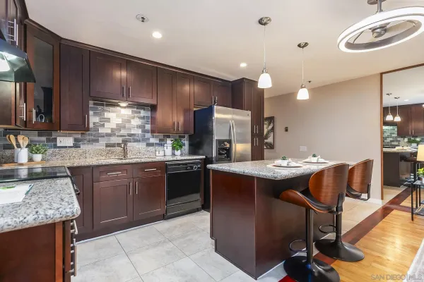 a kitchen with a sink and wooden cabinets