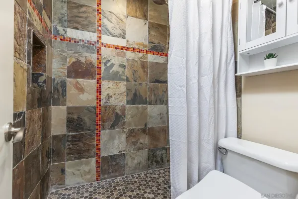 a bathroom with sink granite and mirror
