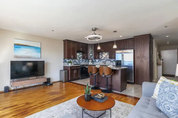 a view of kitchen with stainless steel appliances granite countertop a stove a sink and a dining table