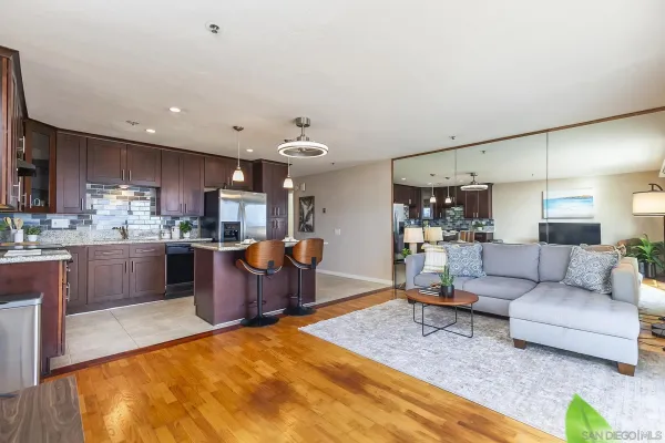 a kitchen with stainless steel appliances granite countertop a stove refrigerator and cabinets