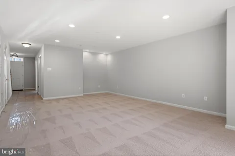 a kitchen with stainless steel appliances granite countertop white cabinets and a stove top oven