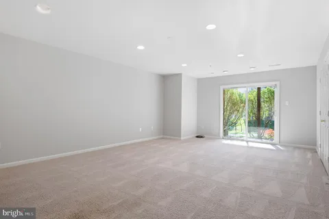 a view of empty room with stairs and windows