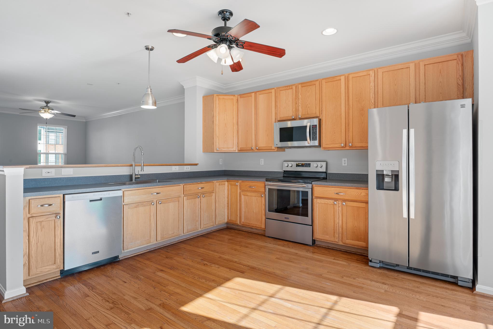 511 Ellison Court Frederick, MD 21703 - Photo 18 of 79 a kitchen with granite countertop a refrigerator stove top oven and sink