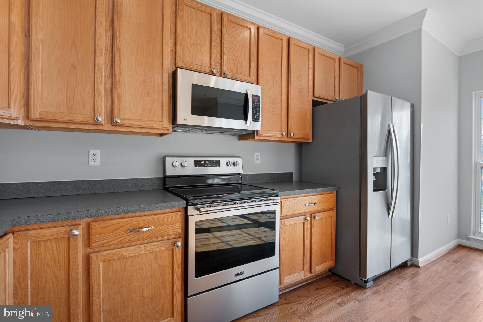 511 Ellison Court Frederick, MD 21703 - Photo 19 of 79 a kitchen with stainless steel appliances granite countertop white cabinets and a stove top oven
