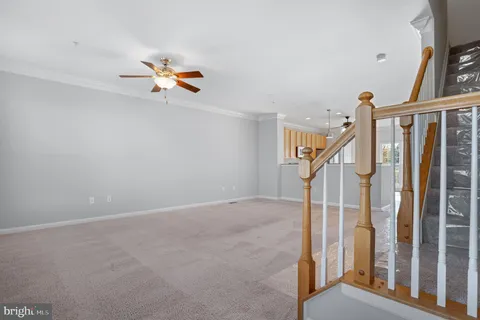 a view of a bedroom with a bed and a chandelier fan