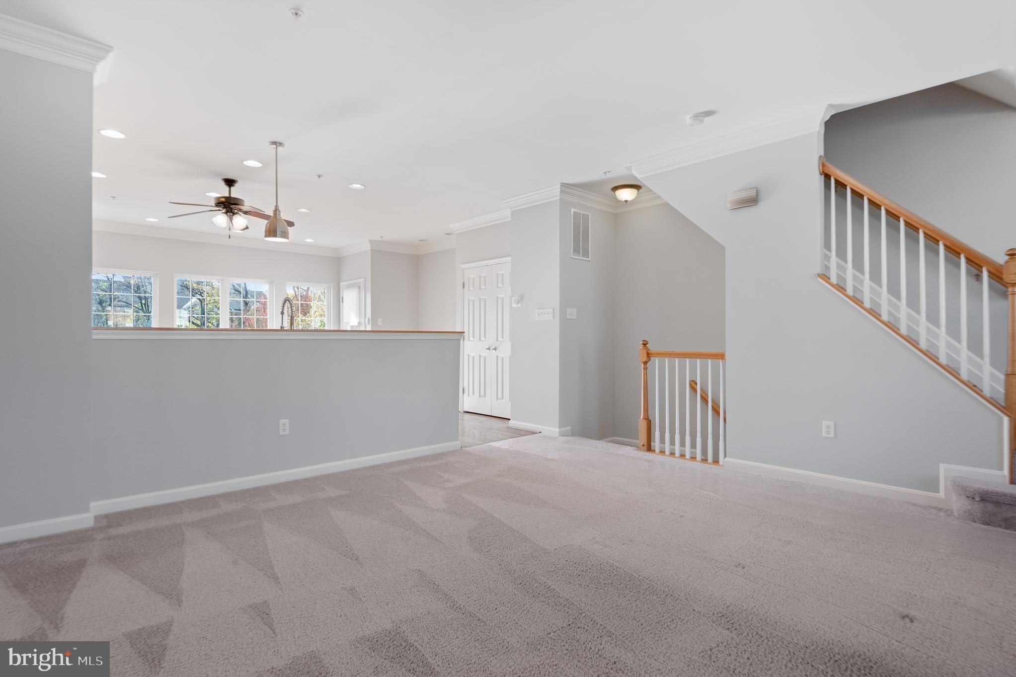 511 Ellison Court Frederick, MD 21703 - Photo 33 of 79 a view of a hallway with wooden floor and staircase