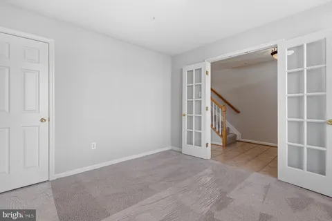 a bathroom with a granite countertop toilet a sink and a mirror