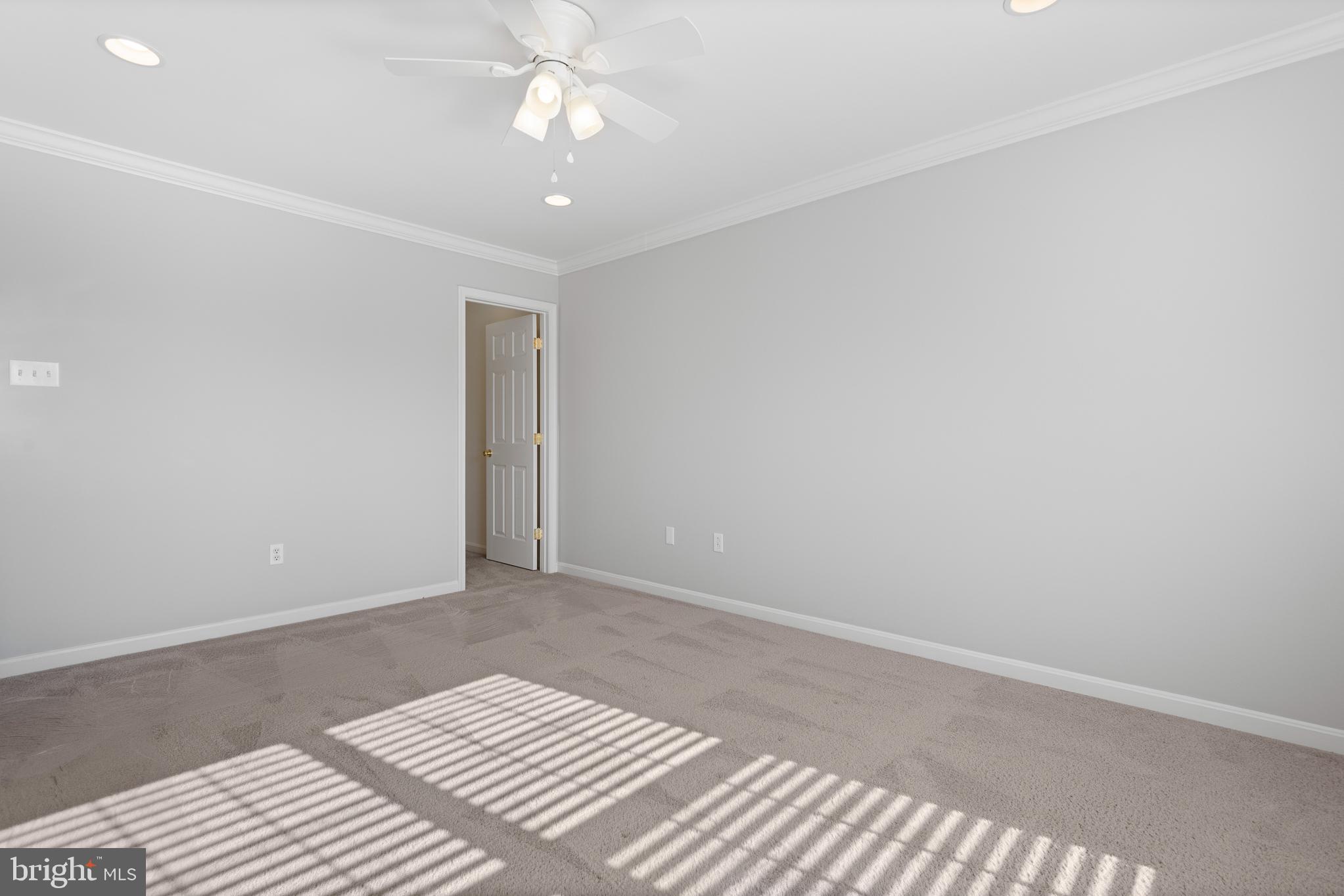 511 Ellison Court Frederick, MD 21703 - Photo 49 of 79 a view of a bedroom with a bed and a chandelier fan