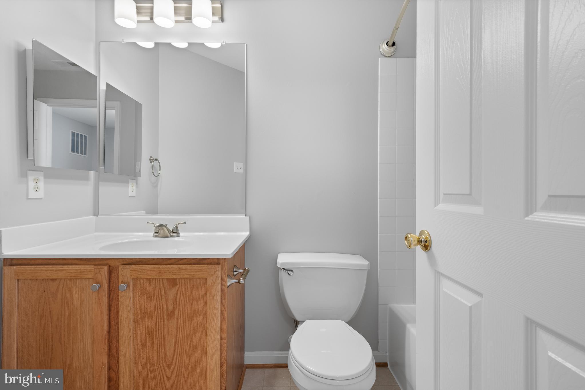 511 Ellison Court Frederick, MD 21703 - Photo 51 of 79 a bathroom with a granite countertop sink toilet and mirror