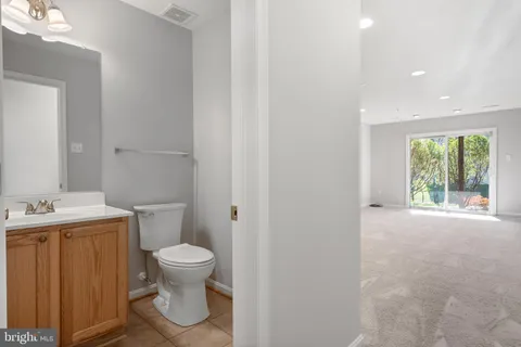 a kitchen with granite countertop a refrigerator stove top oven and sink