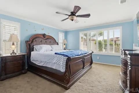 a living room with a bed furniture and a large window