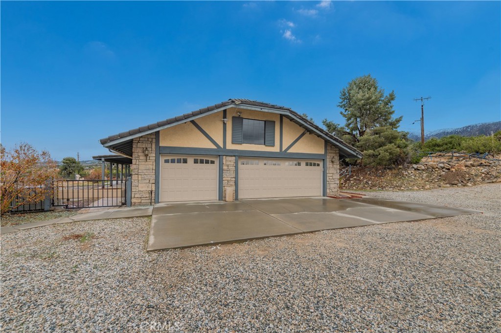 9539 Soledad Road Pinon Hills, CA 92372 - Photo 16 of 66 a view of a house with a yard and garage