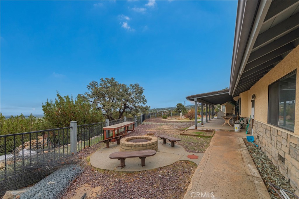 9539 Soledad Road Pinon Hills, CA 92372 - Photo 17 of 66 a view of a patio with table and chairs and potted plants