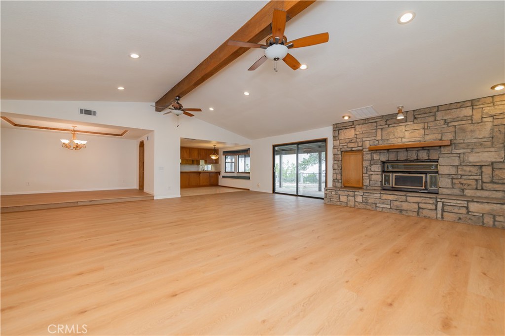 9539 Soledad Road Pinon Hills, CA 92372 - Photo 20 of 66 an empty room with fireplace and windows