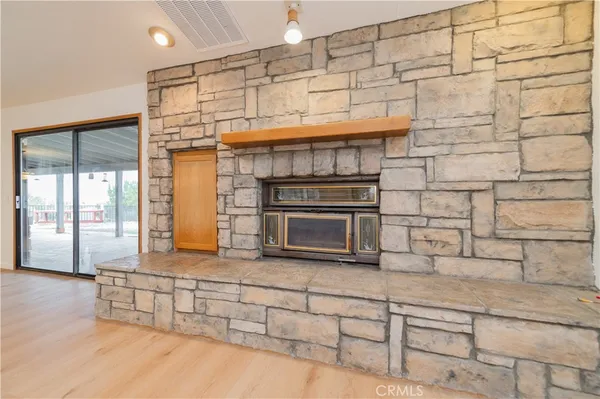a kitchen with stainless steel appliances granite countertop a stove a sink dishwasher and a view of living room