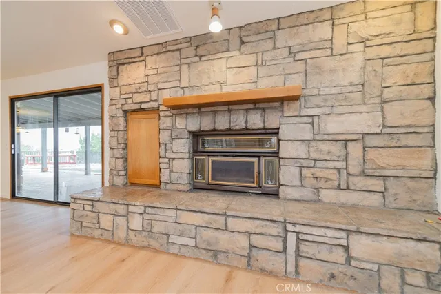 a kitchen with stainless steel appliances granite countertop a stove a sink dishwasher and a view of living room