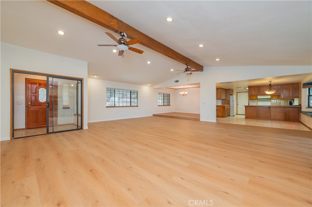 9539 Soledad Road Pinon Hills, CA 92372 - Photo 22 of 66 a view of an empty room with a window and a kitchen