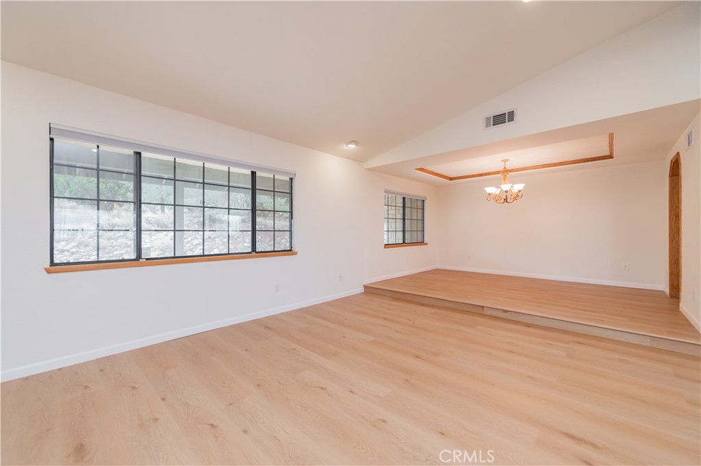 9539 Soledad Road Pinon Hills, CA 92372 - Photo 23 of 66 a view of empty room with wooden floor and fan