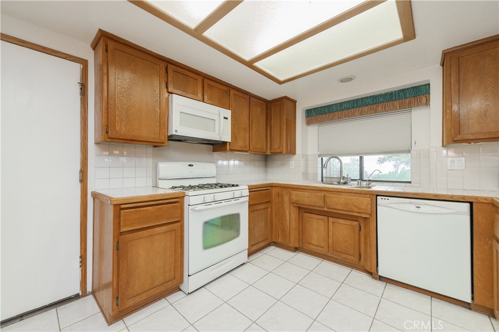 9539 Soledad Road Pinon Hills, CA 92372 - Photo 29 of 66 a kitchen with granite countertop cabinets stainless steel appliances and a sink