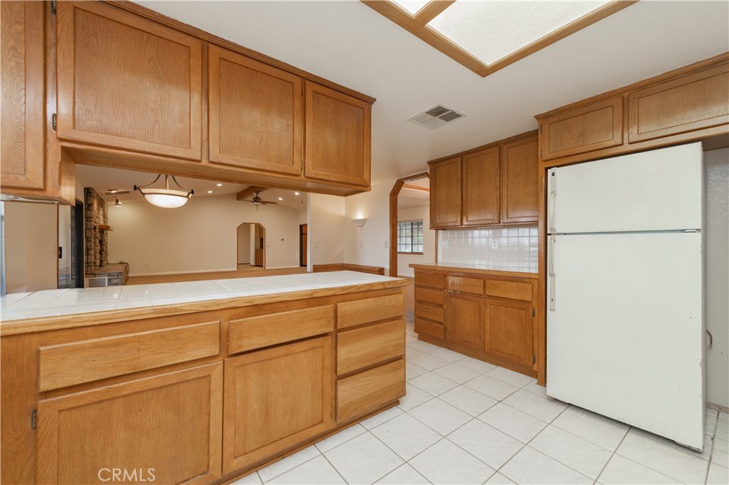 9539 Soledad Road Pinon Hills, CA 92372 - Photo 32 of 66 a kitchen with stainless steel appliances a refrigerator and cabinets
