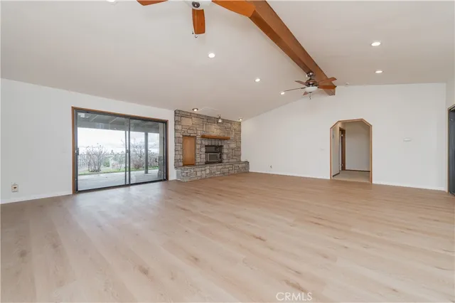 an empty room with a ceiling fan and a window