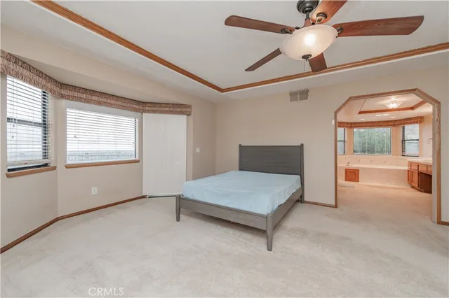 an empty room with a window and a ceiling fan