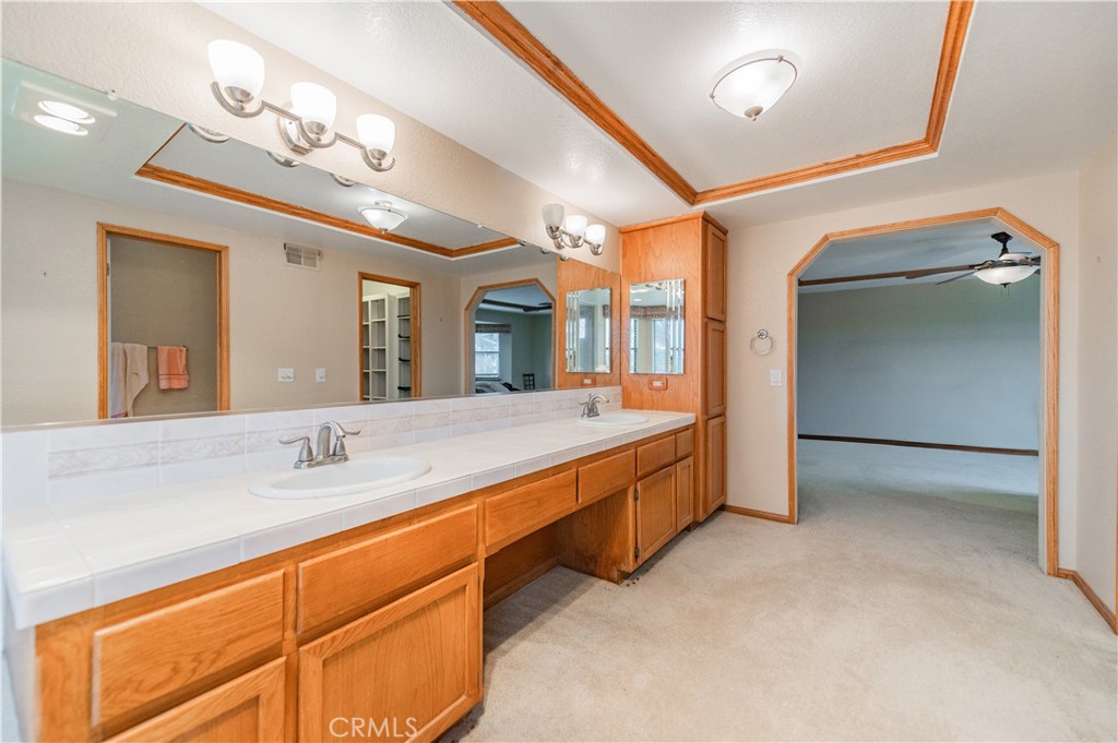 9539 Soledad Road Pinon Hills, CA 92372 - Photo 44 of 66 a spacious bathroom with a double vanity sink and a mirror