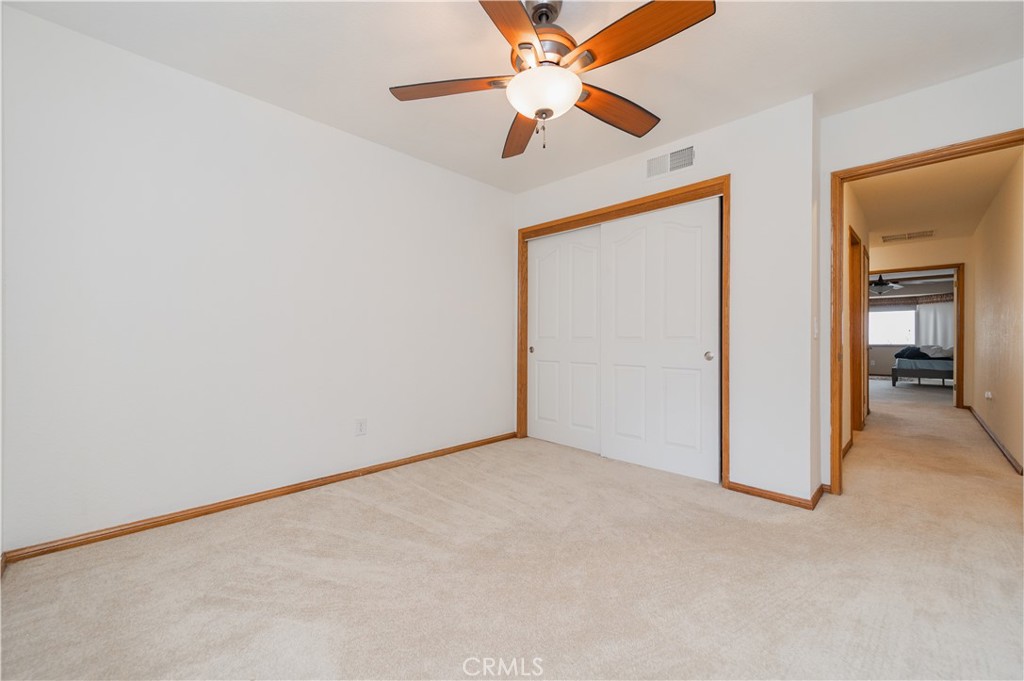9539 Soledad Road Pinon Hills, CA 92372 - Photo 48 of 66 an empty room with a ceiling fan and a window
