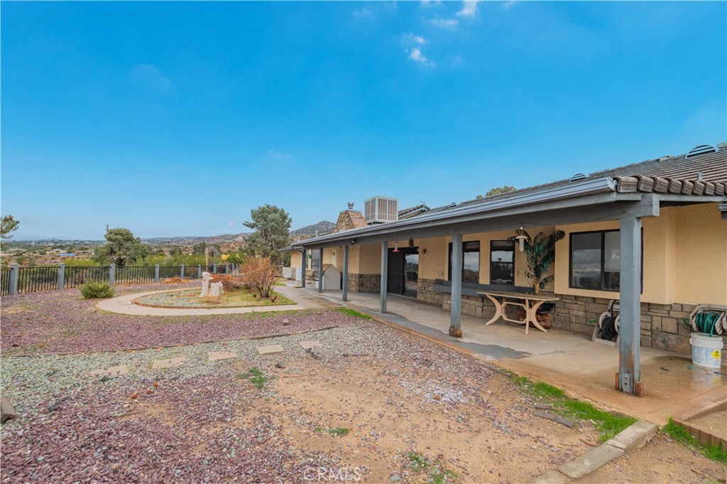9539 Soledad Road Pinon Hills, CA 92372 - Photo 64 of 66 a backyard of a house with table and chairs