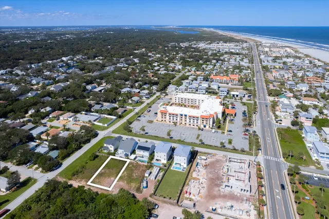 an aerial view of residential houses with outdoor space and swimming pool