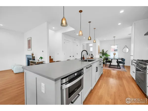 a large kitchen with kitchen island a sink a counter space and stainless steel appliances