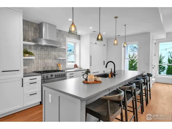 a kitchen with stainless steel appliances granite countertop a stove a sink and a stove